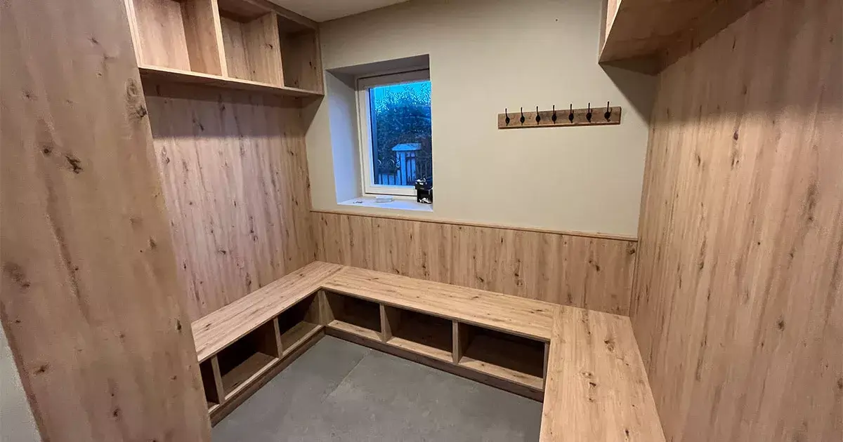 Custom boot room cabinets and storage units crafted in Kilkenny featuring a built in boot room bench, open shelving, and bespoke boot room furniture.